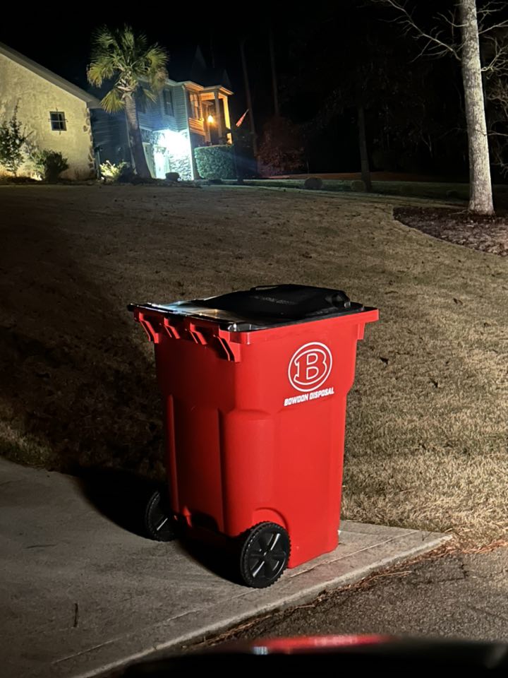 Bowdon Disposal red cart at the curb ready for pickup